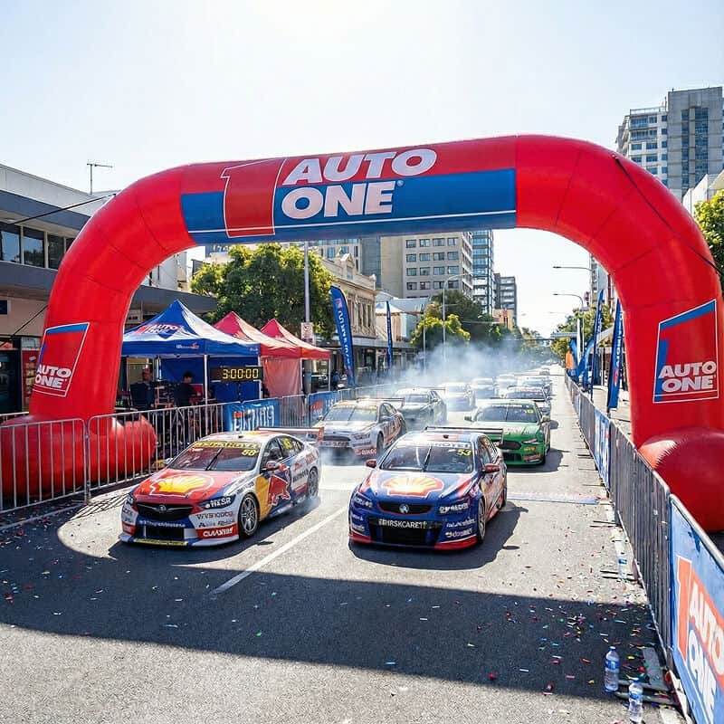 Race cars under inflatable archway