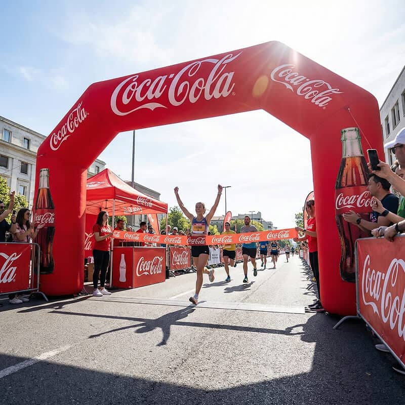Running underneath Coca Cola inflatable archway